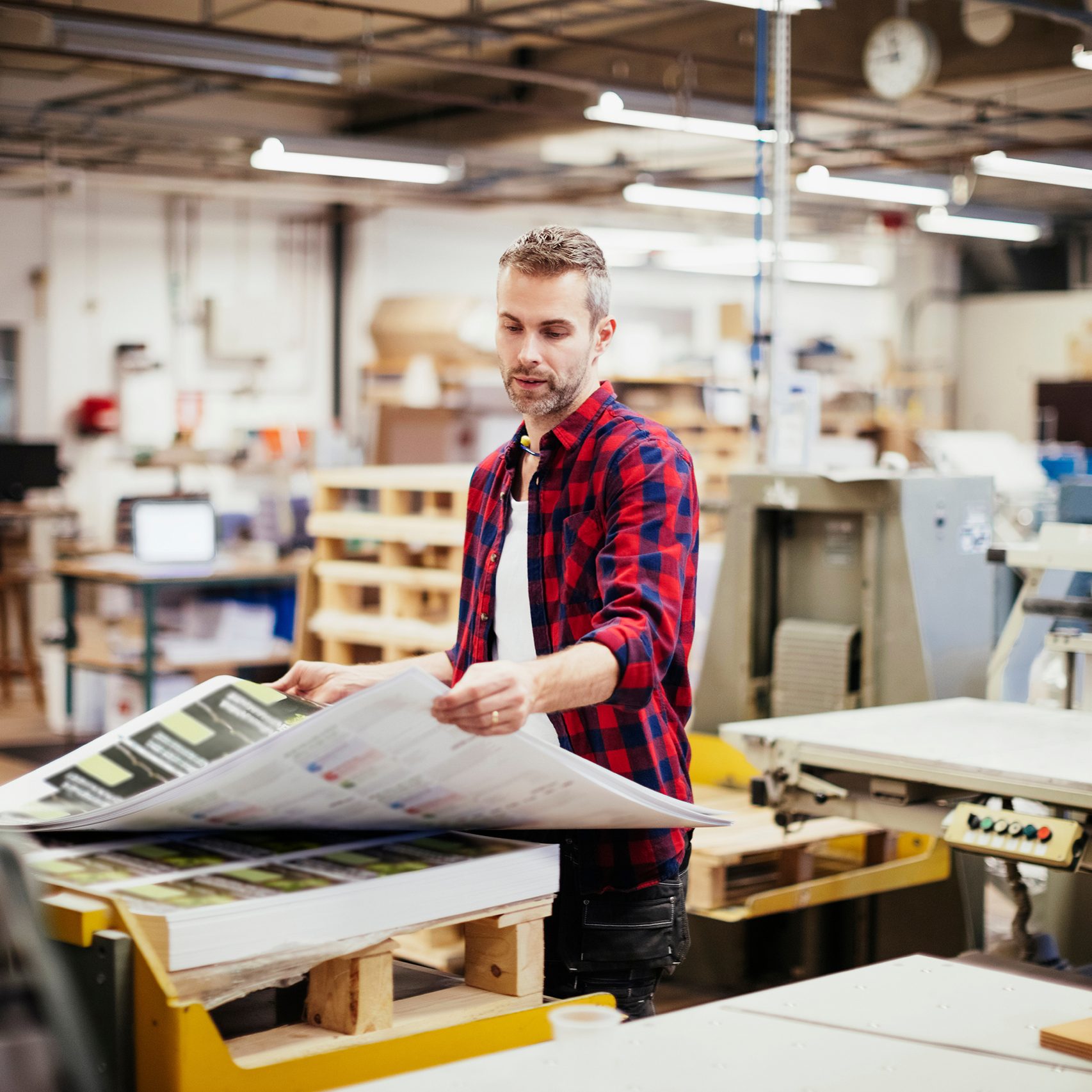 Photo of a man working  in printing factory